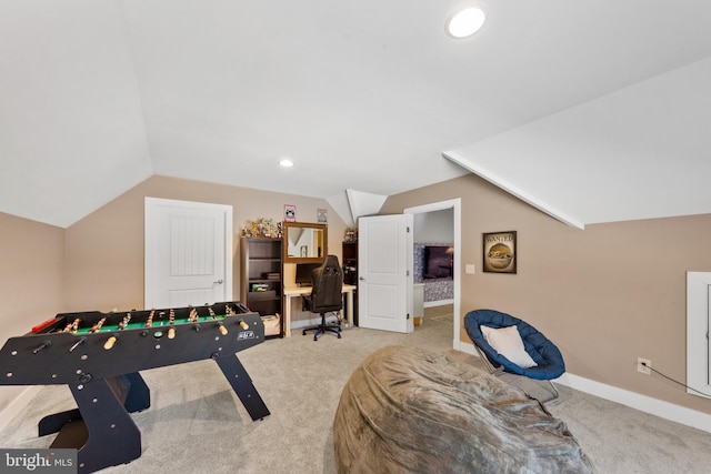 rec room featuring vaulted ceiling and light carpet