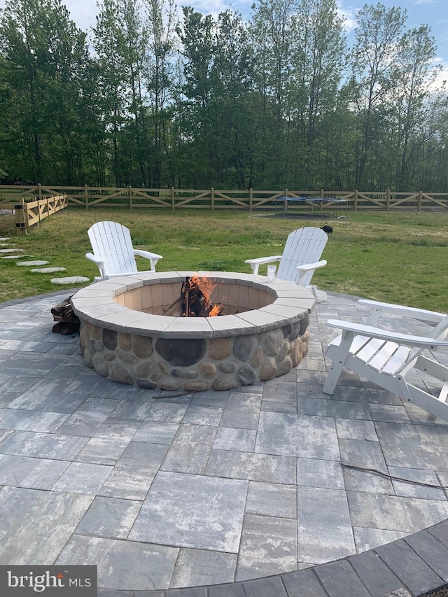 view of patio / terrace with an outdoor fire pit and a rural view