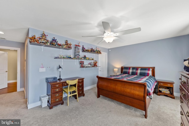 bedroom featuring light carpet and ceiling fan