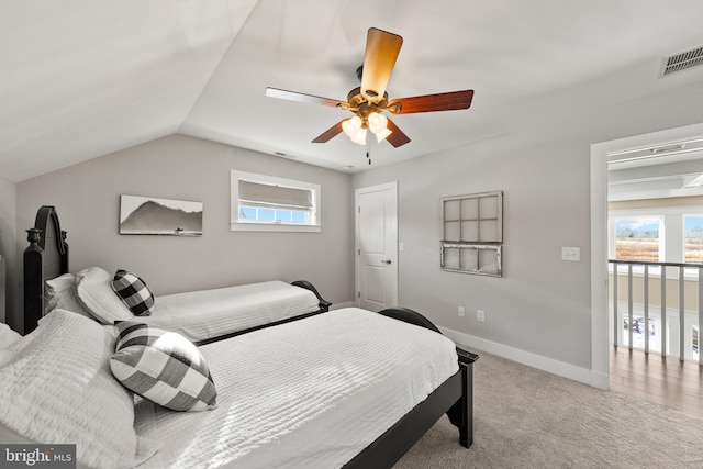 carpeted bedroom featuring lofted ceiling and ceiling fan