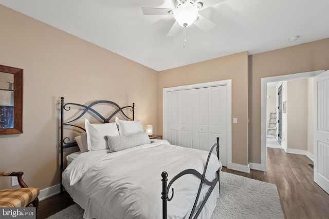 bedroom featuring ceiling fan, a closet, and dark hardwood / wood-style floors