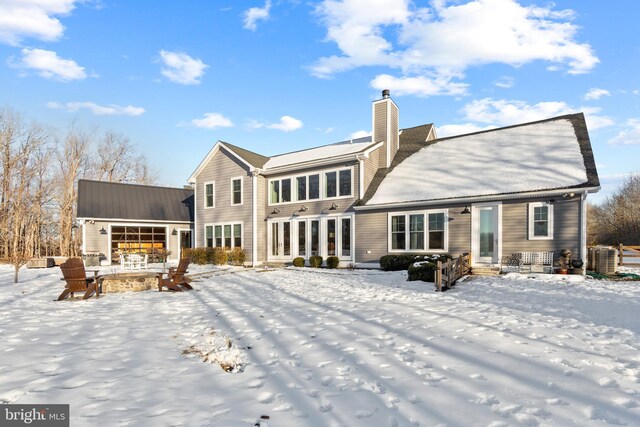 view of snow covered back of property