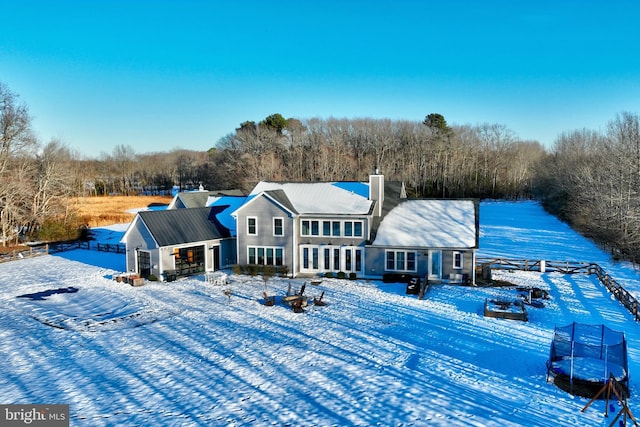 snow covered property with a trampoline