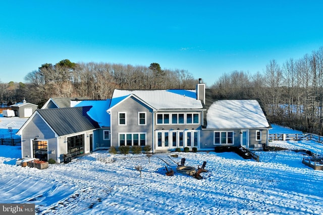 snow covered property featuring a garage