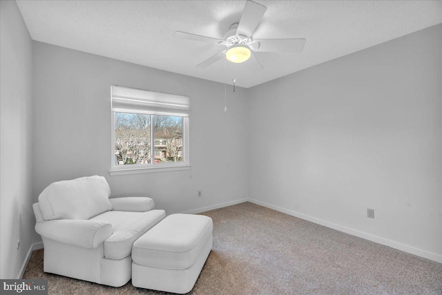 sitting room featuring carpet floors and ceiling fan