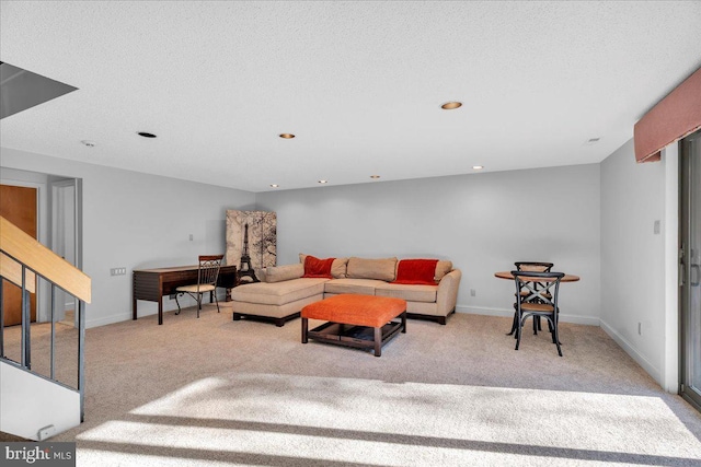 carpeted living room featuring a textured ceiling