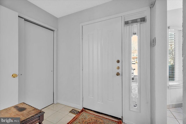 tiled entrance foyer featuring a healthy amount of sunlight