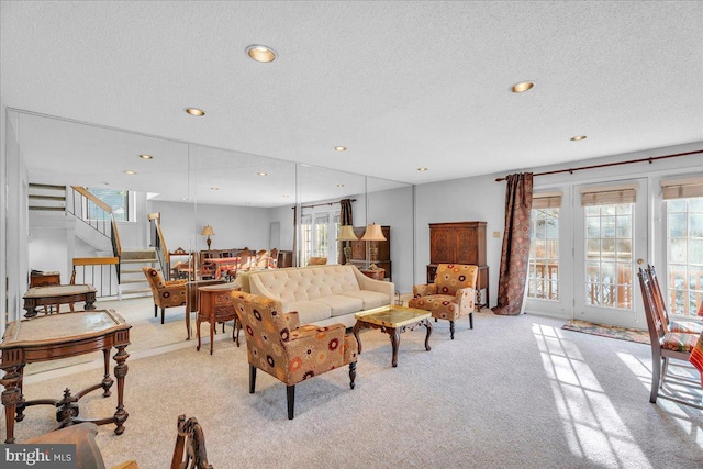 living room featuring light carpet and a textured ceiling