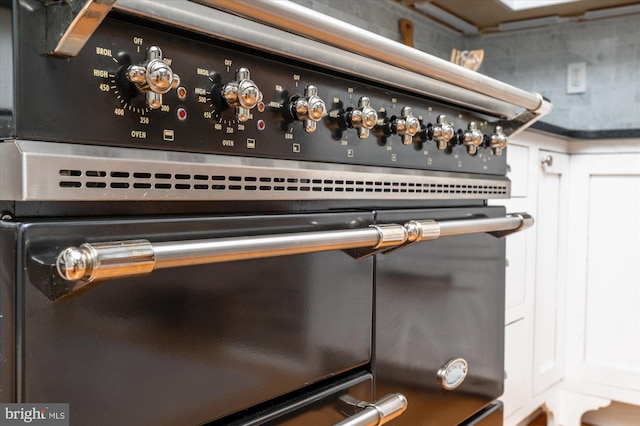 interior details with stove and white cabinetry