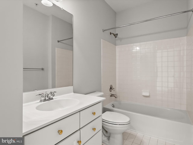 bathroom featuring washtub / shower combination, tile patterned flooring, vanity, and toilet