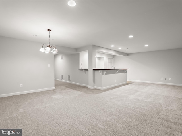 unfurnished living room with visible vents, baseboards, recessed lighting, and light colored carpet