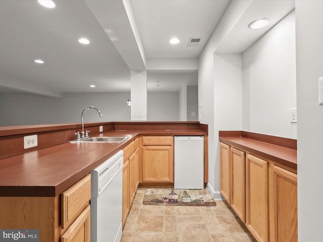 kitchen with dishwasher, a sink, visible vents, and recessed lighting