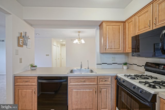 kitchen featuring black appliances, hanging light fixtures, a notable chandelier, decorative backsplash, and sink