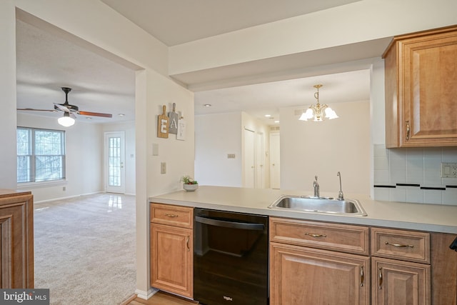 kitchen featuring dishwasher, light carpet, sink, backsplash, and ceiling fan with notable chandelier