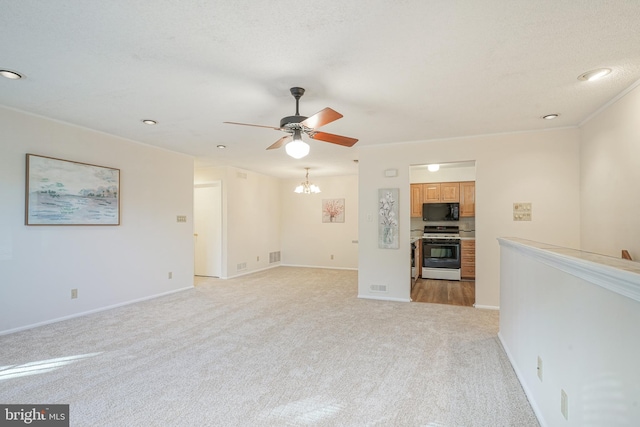 unfurnished living room with ceiling fan with notable chandelier and light carpet