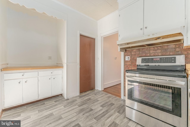 kitchen featuring stainless steel electric stove, white cabinets, a textured ceiling, and light hardwood / wood-style flooring