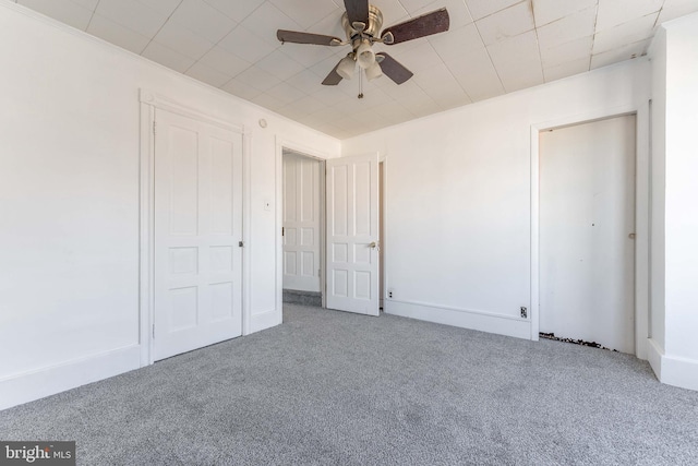 unfurnished bedroom featuring ceiling fan and carpet