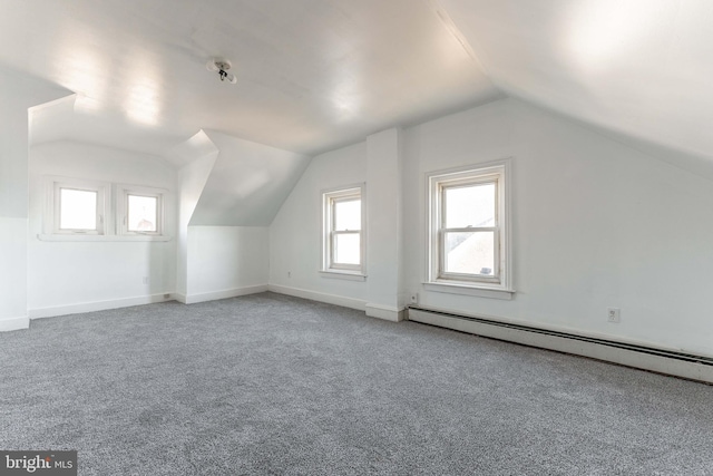 bonus room with carpet floors, baseboard heating, and vaulted ceiling