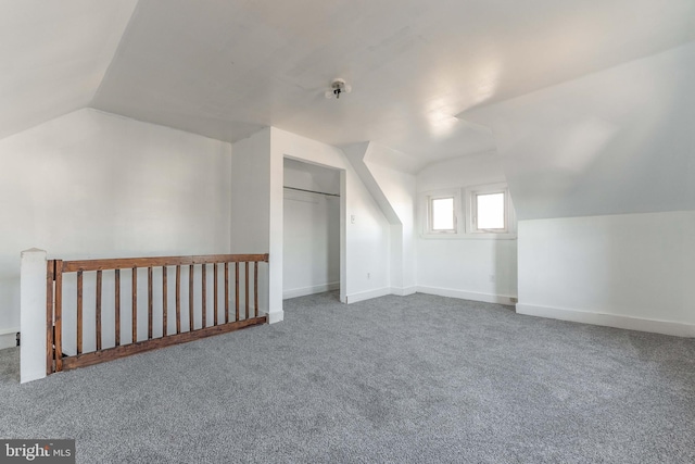 bonus room featuring vaulted ceiling and carpet flooring