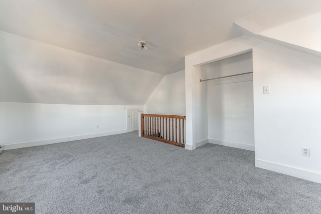 additional living space with carpet floors and vaulted ceiling