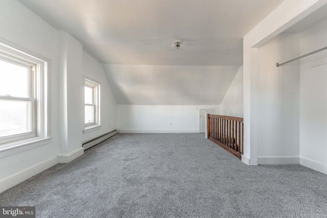 bonus room with lofted ceiling, baseboard heating, and carpet