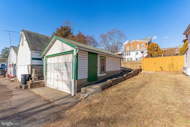 view of side of home with a garage and an outdoor structure