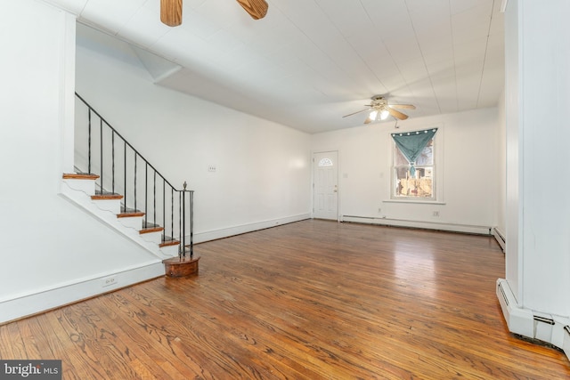 unfurnished living room with hardwood / wood-style flooring and a baseboard radiator