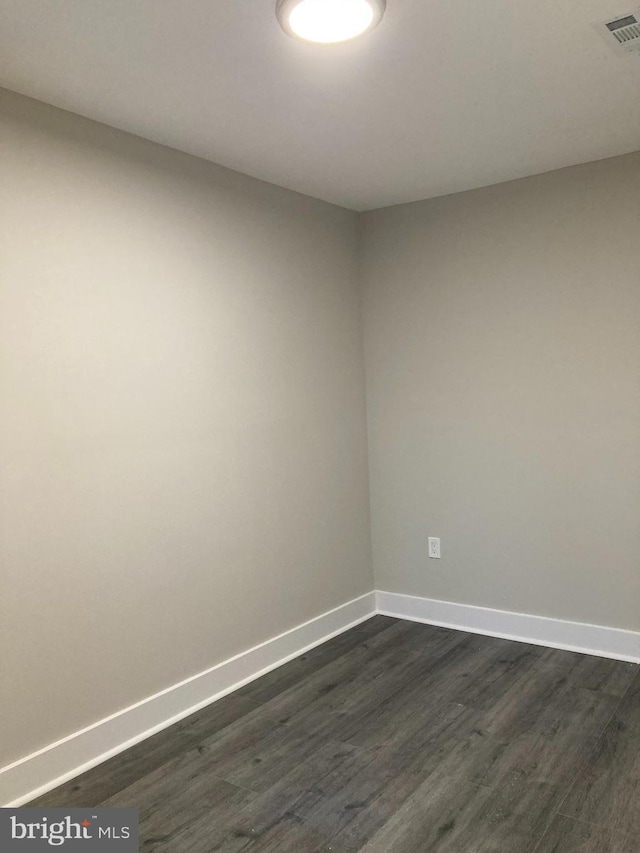 empty room featuring dark wood-type flooring