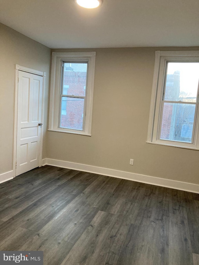 spare room featuring dark wood-type flooring