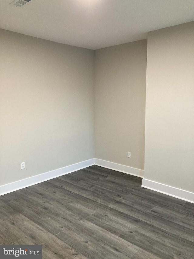 unfurnished room with dark hardwood / wood-style floors