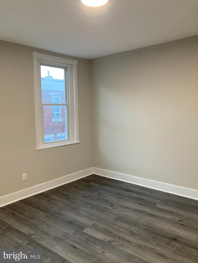 empty room with dark hardwood / wood-style floors