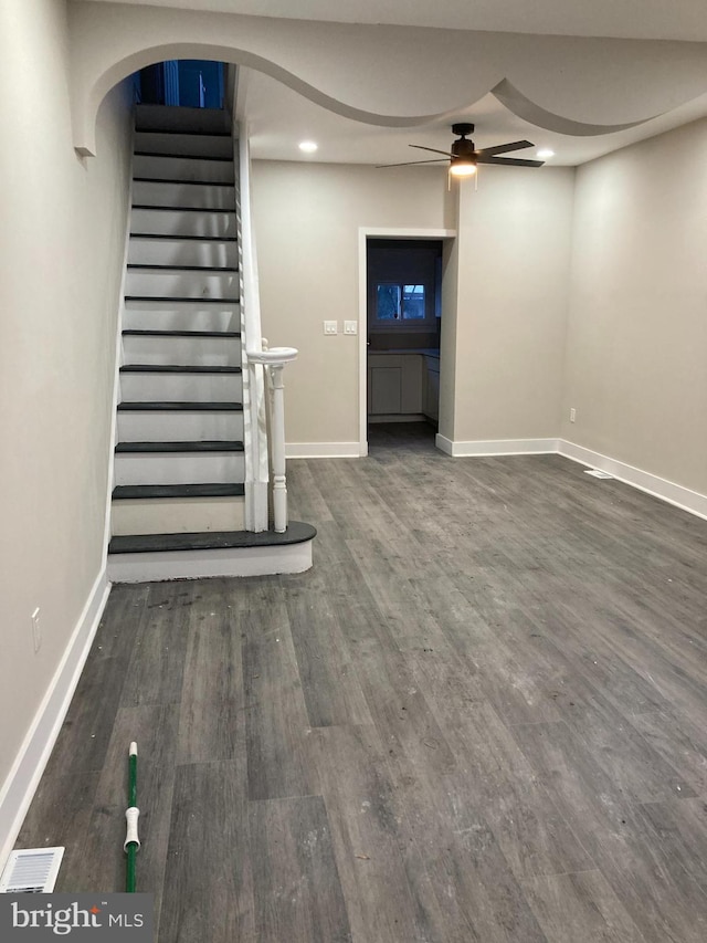 basement with dark hardwood / wood-style floors and ceiling fan