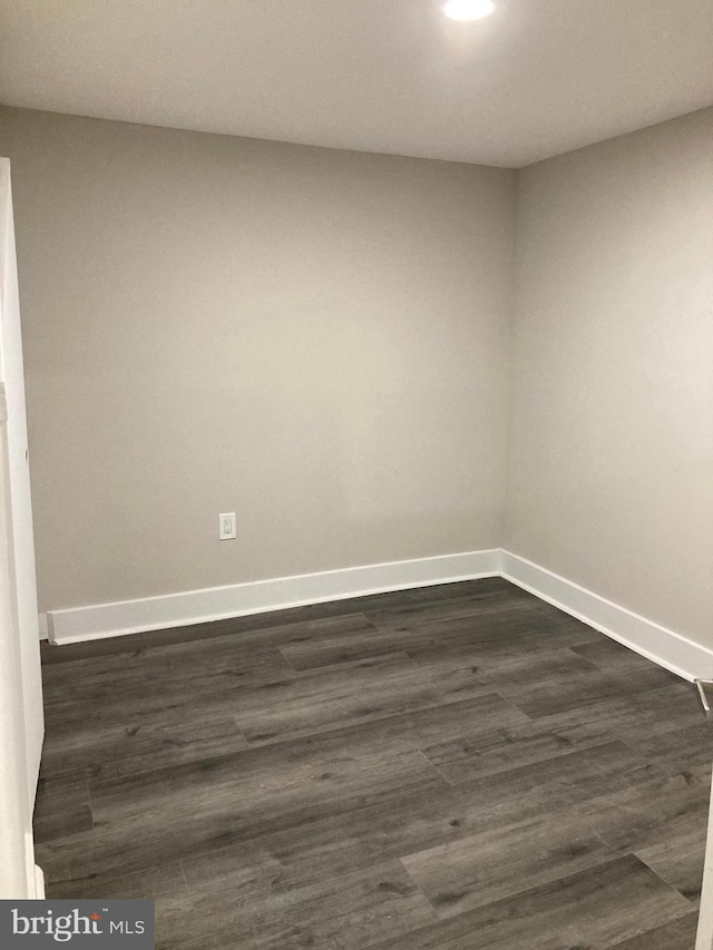 empty room featuring dark wood-type flooring