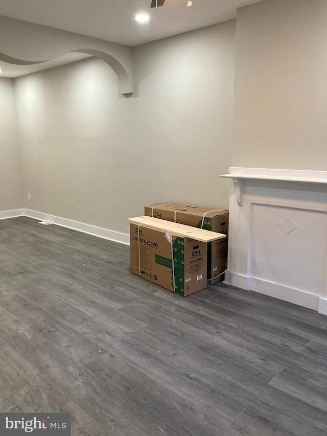 interior space featuring ceiling fan and dark wood-type flooring