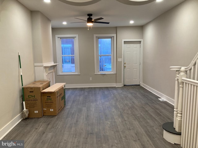 interior space with ceiling fan and dark hardwood / wood-style flooring