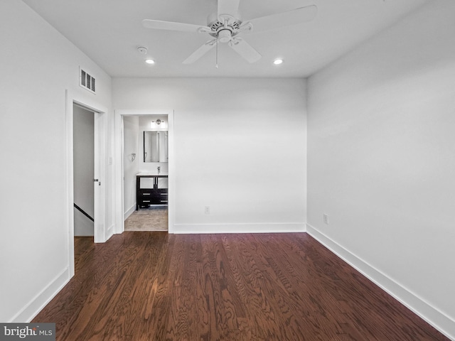 spare room featuring dark wood-type flooring and ceiling fan