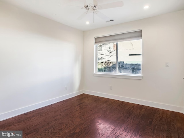 empty room with hardwood / wood-style floors and ceiling fan