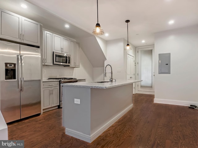 kitchen featuring sink, appliances with stainless steel finishes, dark hardwood / wood-style flooring, electric panel, and an island with sink