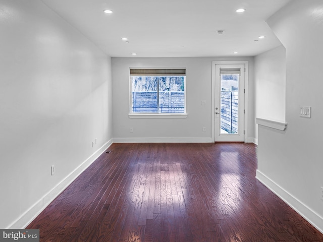 spare room featuring dark hardwood / wood-style flooring