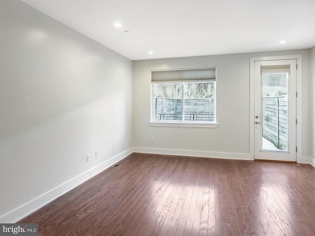 spare room featuring dark wood-type flooring