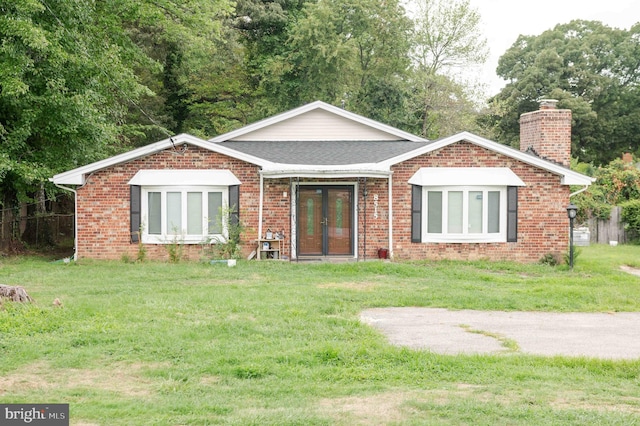 view of front of property featuring french doors and a front lawn