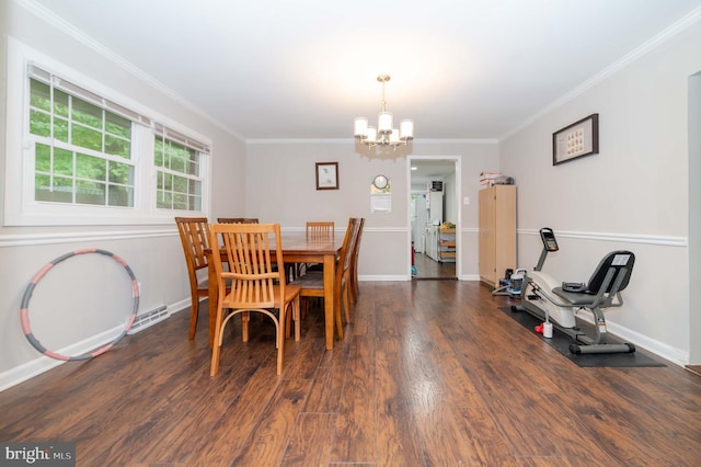 dining area with crown molding, dark wood-type flooring, and a chandelier