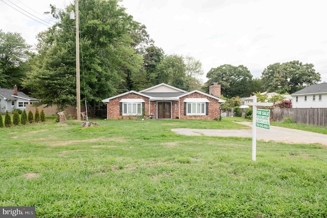 ranch-style home with a front lawn