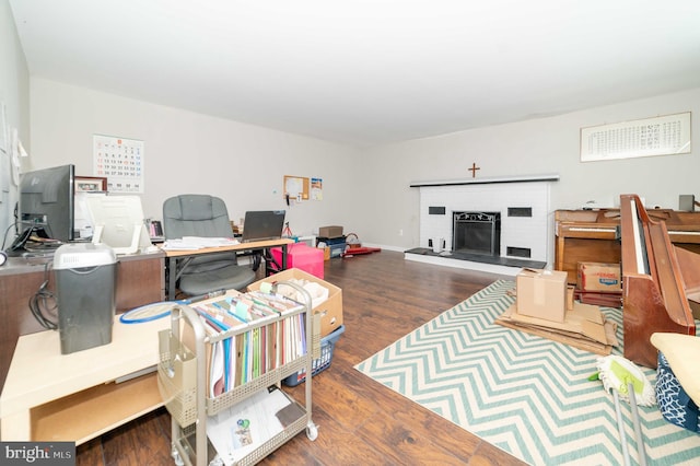 office area featuring a fireplace and dark hardwood / wood-style flooring