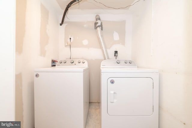 clothes washing area featuring washer and clothes dryer