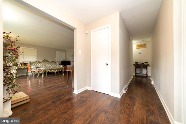 hall with dark hardwood / wood-style flooring