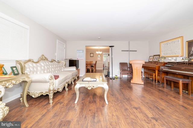 living room featuring dark hardwood / wood-style floors and a notable chandelier