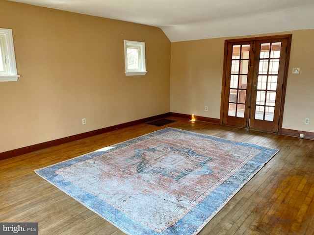 empty room with french doors, wood-type flooring, and visible vents