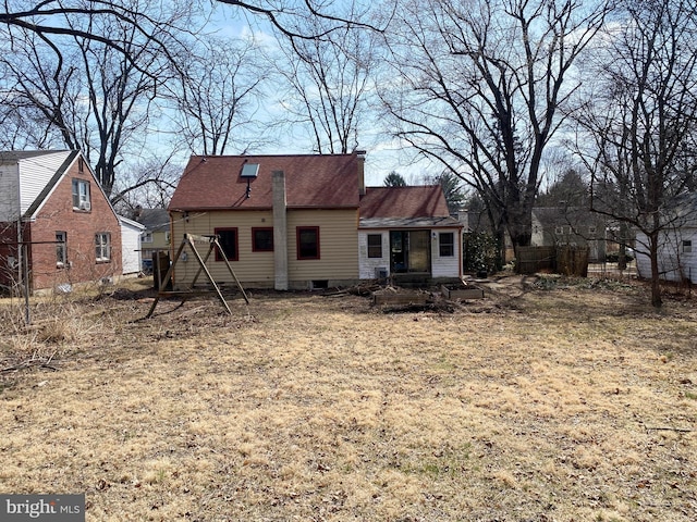 rear view of property with fence and roof with shingles