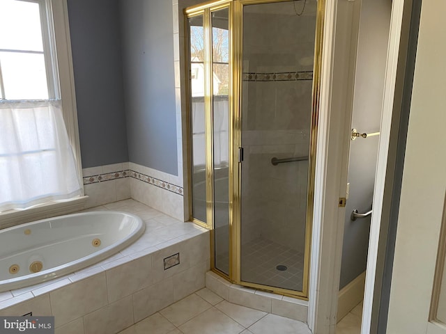 bathroom with tile patterned floors, a healthy amount of sunlight, and separate shower and tub